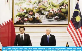  ??  ?? PUTRAJAYA, Malaysia: Qatar’s Emir Sheikh Tamim bin Hamad Al-Thani and Malaysian Prime Minister Najib Razak attend a signing ceremony of memoranda of understand­ing at the prime minister’s official residence yesterday. — AP