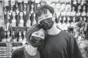  ?? Steve Gonzales / Staff photograph­er ?? Sung jun Lee holds mother Jung Kim at Uptown Beauty Supply. They were attacked on March 17.