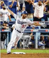  ?? EZRA SHAW / GETTY IMAGES ?? Charlie Culberson hits a home run in Game 2 of the 2017 World Series against the Astros. Culberson went 8 for 18 with four extra-base hits in 10 postseason games.