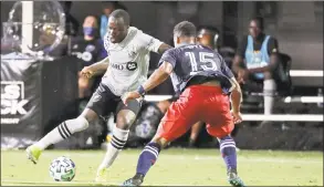  ?? John Raoux / Associated Press ?? The Montreal Impact’s Ballou Jean- Yves Tabla, left, moves the ball against the New England Revolution’s Brandon Bye on Thursday in Kissimmee, Fla.