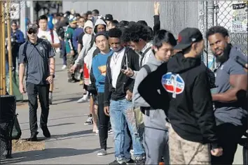  ?? Gary Coronado Los Angeles Times ?? SHOPPERS line up Monday outside Supreme on Fairfax Avenue in L.A. to be assigned numbers to enter the street-wear store Thursday for its merchandis­e “drop.” Previously, people waited outside for days.