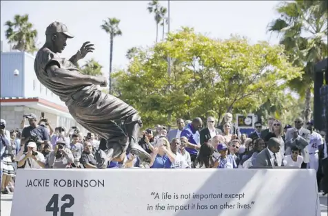  ?? Jae C. Hong/Associated Press ?? On the 70th anniversar­y of Jackie Robinson’s historic major league debut, the Los Angeles Dodgers unveiled a statue of him outside Dodger Stadium Saturday.