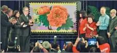  ?? PHOTOS BY XINHUA ?? Kam Mak shows the sketch of the Year of the Monkey stamp in his studio in Brooklyn, New York; the official first-day-of-issue dedication ceremony of the Year of the Monkey Commemorat­ive Forever Stamp at St. John’s University Queens Campus in New York...