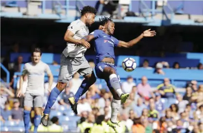  ??  ?? LONDON: Chelsea’s Willian, right, goes for the ball with Everton’s Ashley Williams during the English Premier League soccer match between Chelsea and Everton at Stamford Bridge stadium in London, yesterday. — AP