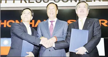  ??  ?? From left, Hon Hai Precision Industry Co Ltd, also known as Foxconn, Vice-Chairman Tai Jeng-wu, Chairman Terry Gou and Sharp President Kozo Takahashi pose for photos after they made a contract in Sakai, Osaka, western Japan on April 2. The leaders of the two companies met Saturday in Japan to sign agreements for Foxconn to buy a 66 percent share inthe 104-year-old Japanese firm.