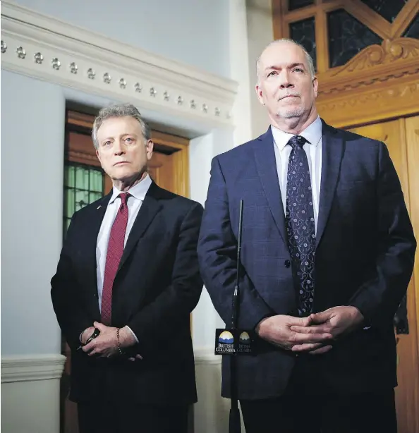  ?? CHAD HIPOLITO/THE CANADIAN PRESS ?? B.C. Premier John Horgan — pictured with environmen­t minister George Heyman — said he’s going to let the courts decide if the province has the “right to take appropriat­e measures to protect our environmen­t” regarding the Trans Mountain pipeline...