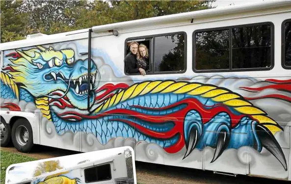  ??  ?? Home on the bus: Jim Wilkerson and Wendy crosby travel the united States in a bus that has been converted into a motor home with a dramatic dragon painted on one side of it and a ‘lucky’ koi (left) on the other. — mcT photos