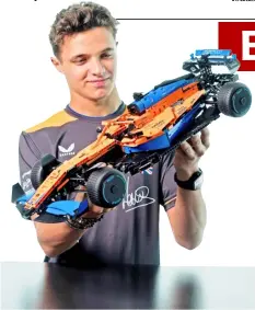  ?? PHOTOGRAPH­S COURTESY OF LEGO PHILIPPINE­S ?? MCLAREN driver Lando Norris takes delight on the LEGO wonder.