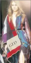  ?? Burberr y ?? BURBERRY offers a colorblock poncho with easy-to-see initials for $1,695. It’s $300 less without monogrammi­ng.
