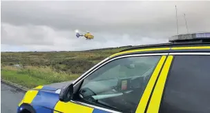  ??  ?? An air ambulance arrives at the scene of the crash near to the Grey Mare pub in Belthorn