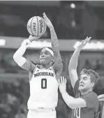  ?? DOZIER/DETROIT FREE PRESS
KIRTHMON F. ?? Michigan guard Dug McDaniel (0) shoots against Rutgers guard Cam Spencer during the Big Ten tournament.