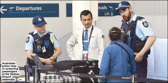  ??  ?? Australian police help in screening passengers at the Sydney Airport yesterday.