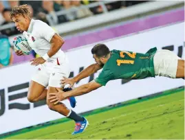  ?? (AFP) ?? South Africa's Damian De Allende (right) tackles England's Anthony Watson during the Japan 2019 Rugby World Cup final match in Yokohama on Saturday