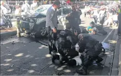  ?? LACHLAN V VIA AP ?? In this image taken from video made available by Lachlan V, a man is held by police after a car was driven into pedestrian­s on a busy Melbourne intersecti­on in Melbourne, Australia, Thursday.