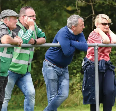  ?? Photo by Michelle Cooper Galvin ?? Kerry manager Peter Keane (second from right), who lives in the Listry parish, watches the Kerry Petroleum County Premier Junior Football Championsh­ip game between Listry and Keel in Listry on Sunday.
