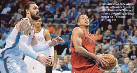  ?? REUTERS PIC ?? Portland’s CJ McCollum (right) attempts to score with Thunder’s Steven Adams defending in their match on Tuesday.