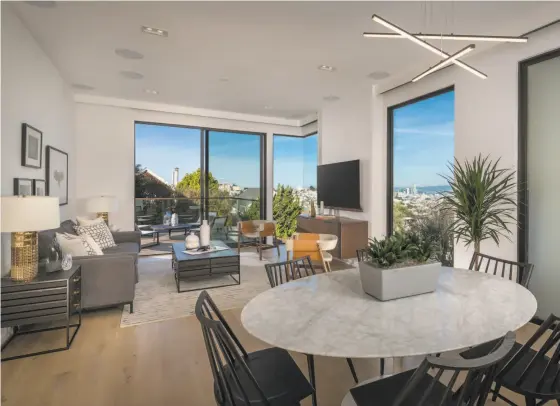  ?? Jacob Elliott ?? Floor-to-ceiling windows frame city views in the great room that opens to a deck at 4326 Cesar Chavez St. in S.F.’s Noe Valley.