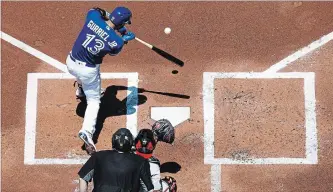  ?? MARK BLINCH GETTY IMAGES ?? Lourdes Gurriel Jr. of the Blue Jays hits a two-run home run against the Baltimore Orioles in the first inning at the Rogers Centre in Toronto on Sunday. The Blue Jays won the game, 6-1, to avoid a sweep by the O’s.