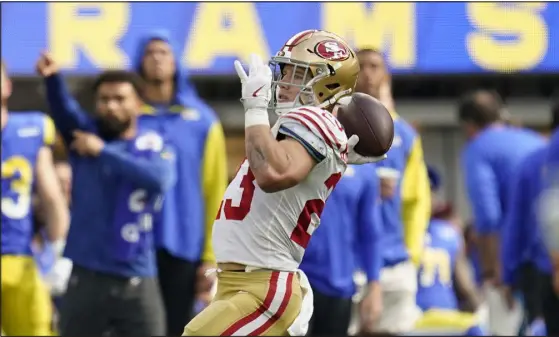  ?? ASHLEY LANDIS — THE ASSOCIATED PRESS ?? San Francisco 49ers running back Christian Mccaffrey passes for a touchdown on a trick play against the Rams pn Sunday in Inglewood, Calif.