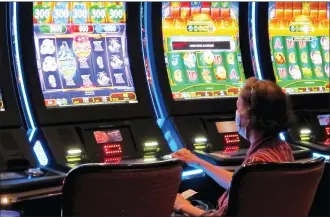  ?? THE ASSOCIATED PRESS ?? A woman plays a slot machine at the Golden Nugget casino in Atlantic City, N.J. Three states authorized sports betting and three others either authorizin­g or expanding casino gambling.