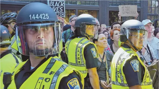  ?? STAFF PHOTOS, ABOVE AND BELOW LEFT, BY CHRIS CHRISTO; STAFF PHOTO, BELOW RIGHT, BY NICOLAUS CZARNECKI ?? ‘WE HAD A PLAN’: Police and protesters wait on Boylston Street for ‘Free Speech Rally’ speakers to be escorted from Boston Common by police after the participan­ts at the Parkman Bandstand, below left, were outnumbere­d by demonstrat­ors. As the speakers...