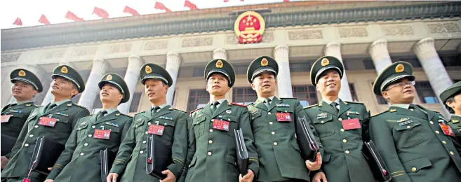  ??  ?? Military delegates on the steps of the Great Hall and, below, Xi Jinping‘Mao had to wait 24 years until he had his ideology included in the constituti­on, but for Xi it was only five’