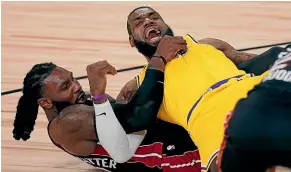  ?? AP ?? LA Lakers superstar Lebron James, right, tangles with Jae Crowder as the Lakers beat the Miami Heat in game one of the NBA finals.