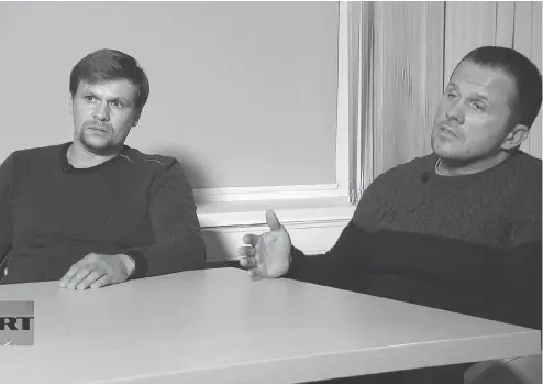  ?? RT CHANNEL VIDEO VIA THE ASSOCIATED PRESS ?? Ruslan Boshirov, left, and Alexander Petrov make their first public appearance in an interview with the RT channel in Moscow earlier this month.