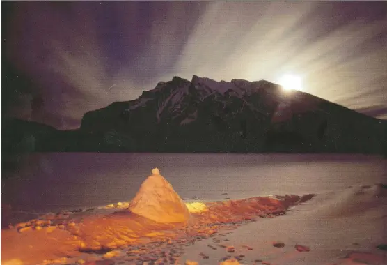  ??  ?? Mountains in the distance at Lake Minnewanka near Banff, from George Brybycin’s book, The Legendary Rockies.