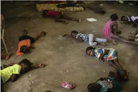  ?? Photograph: Odelyn Joseph/AP ?? Children sleep on the floor of a Port-au-Prince school that was turned into a shelter after they were forced by gang violence to leave their homes.