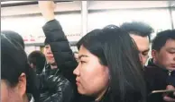  ?? YANG DENGFENG / FOR CHINA DAILY ?? Jiang Jingzi rides the subway in Beijing during the morning travel peak on Feb 16.