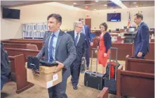  ?? EDDIE MOORE/JOURNAL ?? Attorney Martin Estrada, left, and others file out of the courtroom Friday, the last day of the trial alleging the Public Education Department fails to adequately fund schools. Estrada represents parents and children from different school districts.