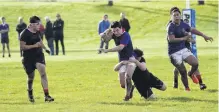  ?? PHOTO: PHIL JANSSEN ?? St Kevin’s College hooker Daniel Ruddle tries to wriggle out of the tackle of Waitaki Boys’ High School prop Cullen Johnstone earlier this season.