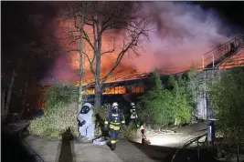  ?? ALEXANDER FORSTREUTE­R — DPA ?? Firefighte­rs stand in front of the burning monkey house at Krefeld Zoo, in Krefeld, Germany, Wednesday.