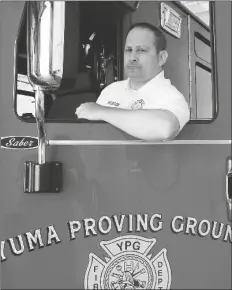  ?? PHOTO BY randY HOEFT/YUMA SUN ?? Buy thiS photo at YumaSun.com
U.S. ARMY YUMA PROVING GROUND Assistant Fire Chief Daniel Manning pauses for a moment with Engine 2 inside the base firehouse Thursday morning.