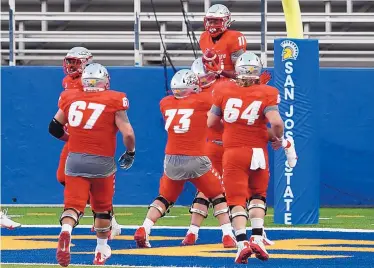  ?? KARL MONDON/BAY AREA NEWS GROUP VIA ASSOCIATED PRESS ?? New Mexico wide receiver Cedric Patterson III (11) is hoisted by teammates after catching a 39-yard touchdown pass in the second quarter Saturday night at San Jose State. The Lobos fell 38-21 in their season opener.