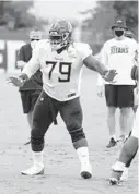  ?? HUMPHREY/AP
MARK ?? Tennessee Titans offensive tackle Isaiah Wilson runs a drill during NFL training camp Aug. 28, 2020, in Nashville, Tennessee.