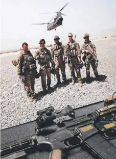  ??  ?? Cameron (second right) with some of the men he fought with on his final day, and his Colt M4 carbine rifle.