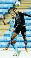  ??  ?? DUEL: Colchester’s Ryan Inniss and Coventry’s Jordan