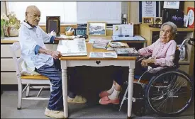  ?? REUTERS ?? The world’s oldest living married couple Masao Matsumoto and his wife Miyako look at albums in their room at a nursing house in Takamatsu, Japan on Tuesday.