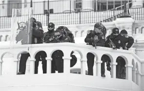  ?? JULIO CORTEZ/AP FILE ?? Police watch as demonstrat­ors try to break through a barrier at the U.S. Capitol. A report says Capitol Police were woefully unprepared.