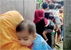  ??  ?? Rohingya refugees being escorted to safety from their safehouse in Mount Lavinia. Pic by Reka Tharangani