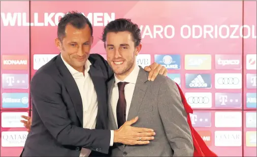  ??  ?? Hasan Salihamidz­ic, director deportivo del Bayern Múnich, abraza al lateral derecho español Álvaro Odriozola en su presentaci­ón.