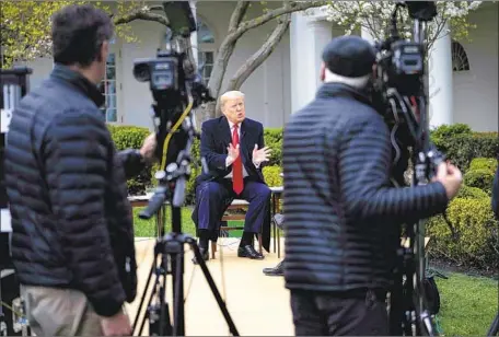  ?? Doug Mills Pool Photo ?? PRESIDENT TRUMP said Tuesday on Fox News that Easter would be a “beautiful time” to have “packed churches” — prompting warnings from health experts and governors of both parties. He later backed off somewhat, saying he would be guided by his task force.