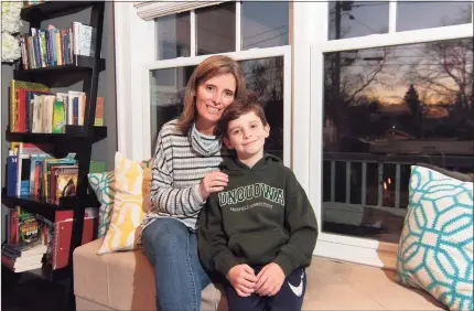  ?? Christian Abraham / Hearst Connecticu­t Media ?? Crissy Kelly with her son James, 9, at their home in Fairfield on Tuesday. James, a student at Unquowa School, attends classes in person.