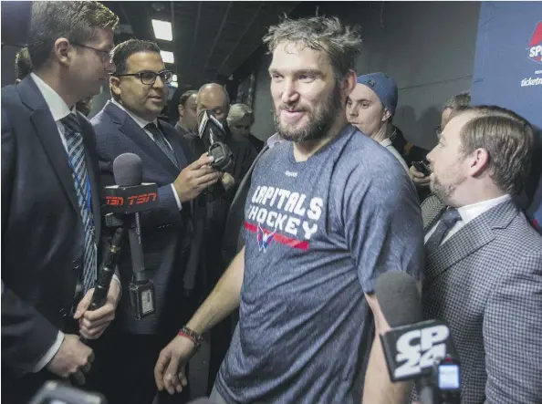  ?? ERNEST DOROSZUK ?? Washington Capitals left wing Alex Ovechkin squeezes past reporters Tuesday at the Air Canada Centre in Toronto. Asked if he still intends to play in the PyeongChan­g Olympics after the NHL ruled out sending its players to the Games, Ovechkin said, “In...