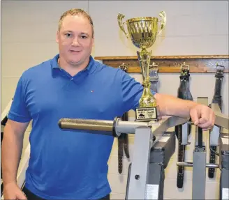  ?? ERIC MCCARTHY/JOURNAL PIONEER ?? George Kinch displays the trophy he won for placing second overall in the Masters Division of the Canadian strongman championsh­ip last month in Waterloo, Que.