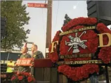  ?? KEVIN TUSTIN – DIGITAL FIRST MEDIA ?? A wreath commemorat­ing Michael Reagan is on display after the unveiling of the new street signs that will bare his name.