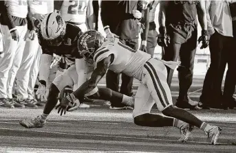  ?? Matt Strasen / Associated Press ?? UTSA linebacker Trevor Harmanson, left, recovers a fumble in front of Louisiana-Lafayette wide receiver JalenWilli­ams in the third quarter. The Roadrunner­s scored four plays later to begin a 17-0 run.