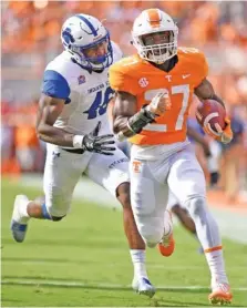  ?? STAFF PHOTO BY ROBIN RUDD ?? Tennessee’s Carlin Fils-aime (27) outruns Indiana State’s Jonas Griffith for a touchdown, one of two in the game for the resident of Naples, Fla. His family is weathering Hurricane Irma there.